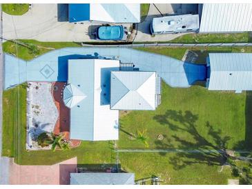 Aerial view of a single-story home with a large yard and driveway at 2075 Pennsylvania Ave, Englewood, FL 34224