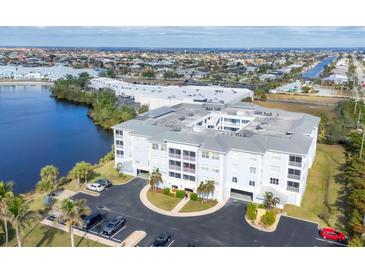 Aerial view of a waterfront condo building with parking and tropical landscaping at 2001 Bal Harbor Blvd # 2203, Punta Gorda, FL 33950
