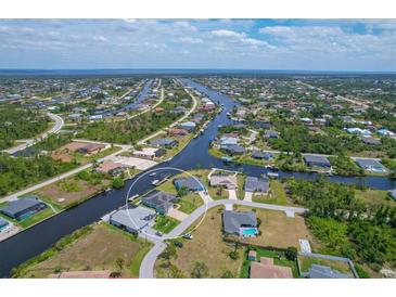 Aerial view of waterfront home with private dock and expansive canal views at 9222 Melody Cir, Port Charlotte, FL 33981