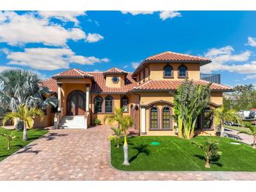 Mediterranean style home with a red tile roof and lush landscaping at 150 Mandalay Rd, Punta Gorda, FL 33950