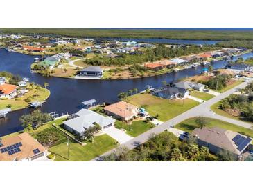 Aerial view of waterfront property and neighborhood at 15546 Viscount Cir, Port Charlotte, FL 33981