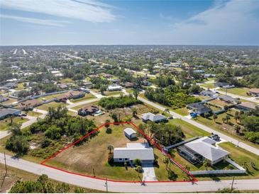 Aerial view of single-story home with spacious lot and surrounding houses at 7379 Rosemont Dr, Englewood, FL 34224