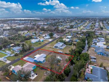 Aerial view of single-story home with canal access and large backyard at 850 E 2Nd St, Englewood, FL 34223