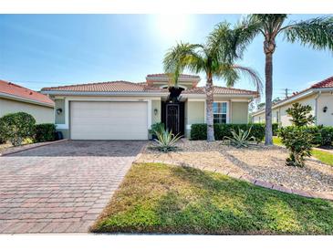 Single-story home with a brick driveway and landscaped yard at 11479 Blackfin St, Venice, FL 34292