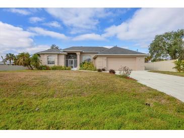 Single-story home with attached garage and well-maintained lawn at 1171 Yarmouth St, Port Charlotte, FL 33952