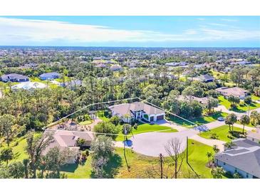 Aerial view of a luxurious home with a large backyard and surrounding landscape at 17 Par View Pl, Rotonda West, FL 33947