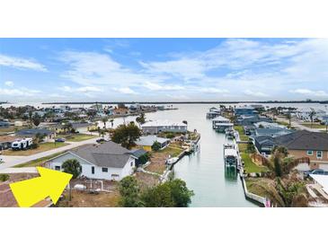 Aerial view of waterfront home with canal access and nearby houses at 1954 Arkansas Ave, Englewood, FL 34224