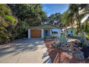 Charming mid-century home with a well-manicured front yard and a two-car garage at 421 Riviera St, Venice, FL 34285