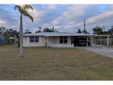 Ranch-style home with carport and spacious yard at 839 E 4Th St, Englewood, FL 34223