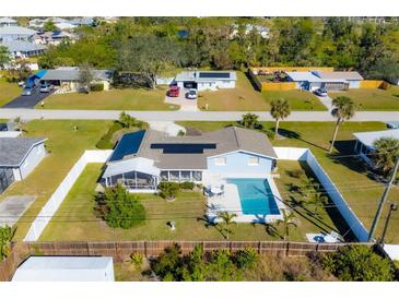 Aerial view of a single-Gathering home with a pool and fenced backyard at 221 E Wentworth St, Englewood, FL 34223