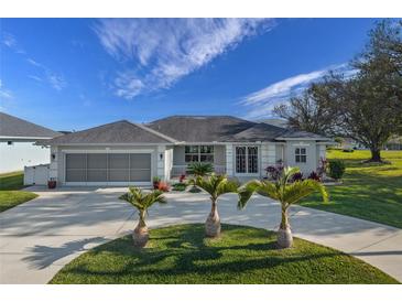 Single-story home with a three-car garage and circular driveway at 249 Sportsman Rd, Rotonda West, FL 33947
