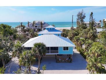 Aerial view of a beach house with ocean views and tropical landscaping at 396 N Gulf Blvd, Placida, FL 33946