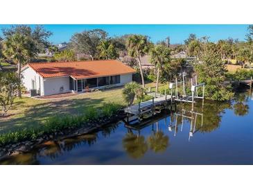 Aerial view of waterfront home with private dock and lush landscaping at 4696 Pompano St, Placida, FL 33946