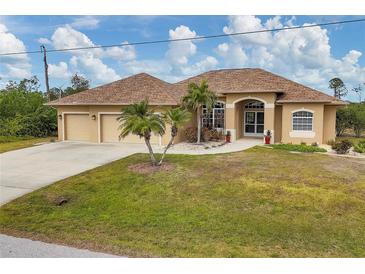 Tan house with three-car garage, palm trees, and a manicured lawn at 116 Hercules Dr, Rotonda West, FL 33947