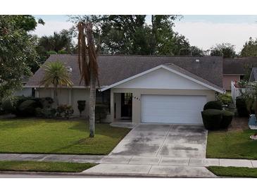 Single story home exterior with a landscaped yard and attached garage at 1441 Strada D Oro, Venice, FL 34292