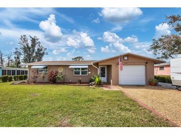 Ranch-style home with a spacious yard and attached garage at 1780 Morning Dove Ln, Englewood, FL 34224