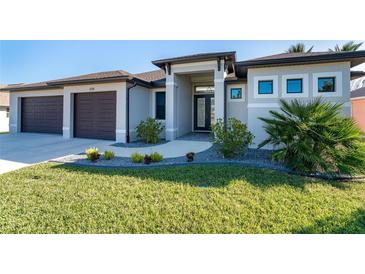 Front view of house with walkway and landscaping at 226 Rotonda N Blvd, Rotonda West, FL 33947