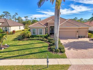 Single-Gathering home with tile roof, landscaped yard, and two-car garage at 2744 Mill Creek Rd, Port Charlotte, FL 33953