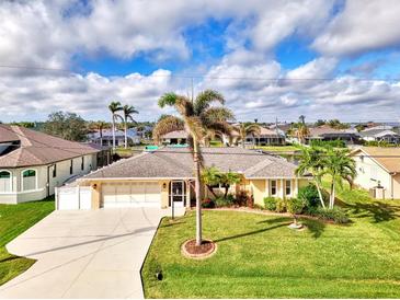 Aerial view of single-Gathering home with a large yard, pool, and canal access at 5231 Conner Ter, Port Charlotte, FL 33981