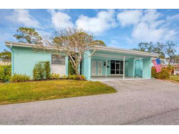 Light teal home with carport and small front yard at 6283 Green View S Cir # 102, Sarasota, FL 34231