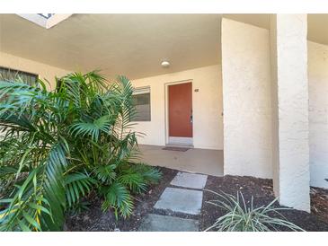 Condo exterior walkway with tropical landscaping at 66 Boundary Blvd # 280, Rotonda West, FL 33947