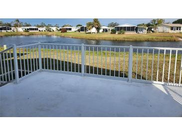 White deck overlooks a pond with views of other homes at 812 Seabrooke Dr, Englewood, FL 34223