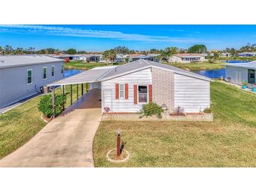 Single-story home with carport and landscaped lawn at 812 Seabrooke Dr, Englewood, FL 34223