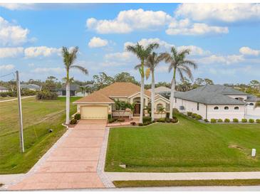 Single-Gathering home with a large yard, palm trees, and a long driveway at 185 Rotonda E Blvd, Rotonda West, FL 33947
