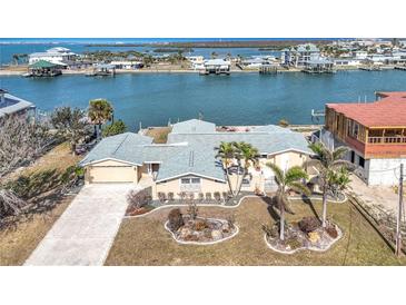 Aerial view of waterfront home with landscaped yard and canal access at 1924 Mississippi Ave, Englewood, FL 34224