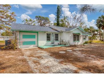 Single-story house with attached garage, needs some TLC at 321 S Mango St, Englewood, FL 34223
