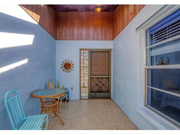 Inviting front entry with tiled floor, and small table with chairs at 610 Apple Ln, Englewood, FL 34223