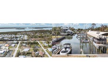 Aerial view showing waterfront property with boat docks and surrounding homes at 8164 Robert St, Englewood, FL 34224