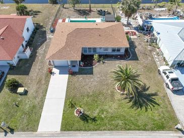 Aerial view of single-Gathering home with pool and landscaped yard at 93 Rotonda Cir, Rotonda West, FL 33947