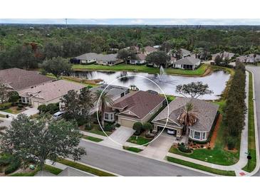 Aerial view of home with lake access in Pennington Place community at 9507 Carnaby Dr, Venice, FL 34293