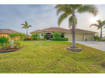 Beautiful one-story home with a three-car garage and lush landscaping at 1 Sportsman Ter, Rotonda West, FL 33947