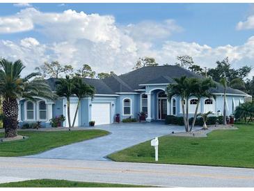 Charming one-story home with a beautiful yard, front-entry garage, and light blue paint at 1061 Boundary Blvd, Rotonda West, FL 33947