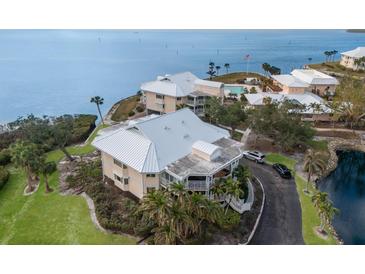 Aerial view of waterfront property with a private driveway and lush landscaping at 11000 Placida Rd # 201, Placida, FL 33946