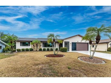 Single-story home with palm trees and a well-maintained lawn at 1505 Fireside St, Port Charlotte, FL 33952