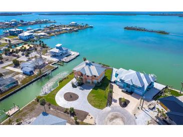 Aerial view of waterfront home with private dock and circular driveway at 1901 Illinois Ave, Englewood, FL 34224