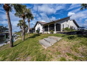 Waterfront home with canal access, lush landscaping, and screened patio at 367 Englewood Isles Pkwy # 4, Englewood, FL 34223