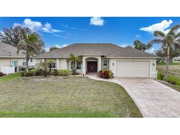 Charming single-story home with a well-manicured lawn and a two-car garage at 8 Broadmoor Ln, Rotonda West, FL 33947