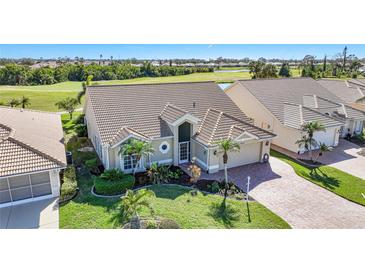 Attractive single-story home with a landscaped yard, located on a golf course at 8377 Parkside Dr, Englewood, FL 34224