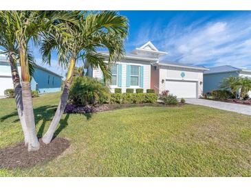 Bright and airy home with palm trees and a manicured lawn at 8960 Scallop Way, Placida, FL 33946