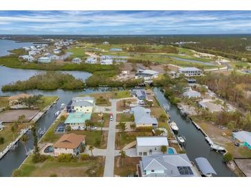 Aerial view of waterfront homes and community with golf course at 10451 Sherman St, Englewood, FL 34224