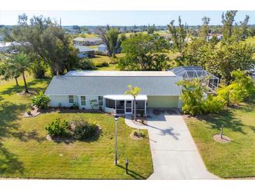 Single-story home with a screened patio and pool, in a peaceful community at 142 Caddy Rd, Rotonda West, FL 33947