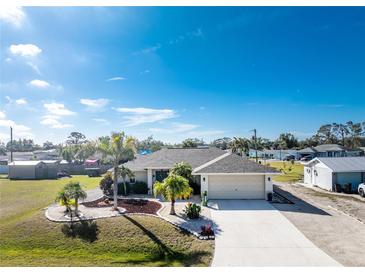 Aerial view of single-story home with landscaped yard and driveway at 1521 Saint Clair Rd, Englewood, FL 34223