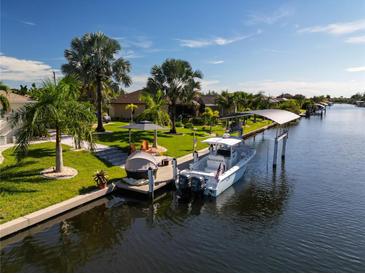 Aerial view of waterfront home with private boat dock at 15794 Viscount Cir, Port Charlotte, FL 33981