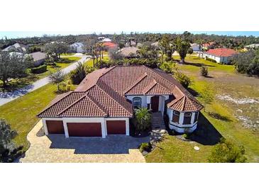 Aerial view of a large house with a three-car garage and a spacious lot at 2 Windward Rd, Placida, FL 33946