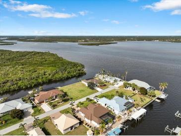 Aerial view of waterfront property with canal access and lush landscaping at 2295 Chilcote Ter, Port Charlotte, FL 33981