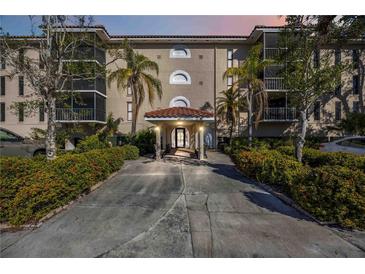 Inviting condo building entrance with lush landscaping at 25188 Marion Ave # C206, Punta Gorda, FL 33950